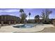 Community pool surrounded by lounge area and landscaping at 600 S Dobson Rd # 175, Mesa, AZ 85202