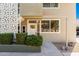 Close-up of a condo exterior featuring a well-lit doorway, manicured bushes, and a modern design at 6107 N 12Th St # 1, Phoenix, AZ 85014