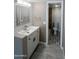 Bright and airy bathroom featuring a modern vanity, elegant mirror, and a glimpse into the shower area at 623 W Guadalupe Rd # 131, Mesa, AZ 85210