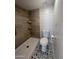 Bathroom featuring a tiled shower with shelves, and a black-and-white pattern floor at 623 W Guadalupe Rd # 131, Mesa, AZ 85210