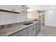 Kitchen sink featuring stainless steel fixtures, light countertops, and white shelving at 623 W Guadalupe Rd # 131, Mesa, AZ 85210