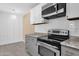 Modern kitchen featuring stainless steel appliances, light countertops, and stylish gray and white cabinetry at 623 W Guadalupe Rd # 131, Mesa, AZ 85210