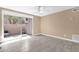 Bright living room with neutral walls, tile flooring, and sliding glass doors to an outdoor patio at 623 W Guadalupe Rd # 131, Mesa, AZ 85210