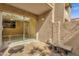 Cozy private patio with stone wall and gravel, complete with pavers leading to sliding glass door at 623 W Guadalupe Rd # 131, Mesa, AZ 85210