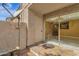 Private patio with sliding glass door, satellite dish, and stone wall, perfect for unwinding after a long day at 623 W Guadalupe Rd # 131, Mesa, AZ 85210