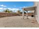 Spacious backyard with a covered patio and block wall surrounding the property at 647 E Palomino Way, San Tan Valley, AZ 85143
