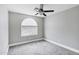 Neutral bedroom with ceiling fan, light gray carpet, and a large window at 647 E Palomino Way, San Tan Valley, AZ 85143