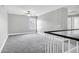 Bright and spacious bonus room with a ceiling fan, light gray carpet, and natural light at 647 E Palomino Way, San Tan Valley, AZ 85143