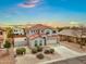 Charming two-story home features a tile roof, desert landscaping, and attached two-car garage at 647 E Palomino Way, San Tan Valley, AZ 85143