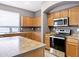 Well-equipped kitchen featuring stainless steel appliances, island, and stylish countertops at 647 E Palomino Way, San Tan Valley, AZ 85143