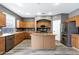 Modern kitchen with stainless steel appliances and an island perfect for entertaining at 647 E Palomino Way, San Tan Valley, AZ 85143