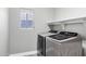 Well-equipped laundry room featuring modern, front-loading washer and dryer at 647 E Palomino Way, San Tan Valley, AZ 85143