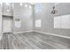 Open living space with soaring ceilings, a chandelier, laminate floors and lots of natural light from multiple windows at 647 E Palomino Way, San Tan Valley, AZ 85143