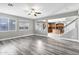 Spacious living room with gray wood floors, open to the kitchen and staircase at 647 E Palomino Way, San Tan Valley, AZ 85143