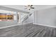Open living room with gray wood floors, leading to the kitchen and staircase at 647 E Palomino Way, San Tan Valley, AZ 85143