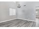 Bright living room with gray wood floors and high ceilings, illuminated by a chandelier at 647 E Palomino Way, San Tan Valley, AZ 85143