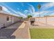 Spacious backyard featuring gravel landscaping, a built-in grill area, and block wall fencing for privacy at 7546 E Clovis Cir, Mesa, AZ 85208