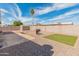 Spacious backyard featuring gravel landscaping, a built-in grill area, and block wall fencing for privacy at 7546 E Clovis Cir, Mesa, AZ 85208