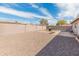 Spacious backyard featuring gravel landscaping, a built-in grill area, and block wall fencing for privacy at 7546 E Clovis Cir, Mesa, AZ 85208