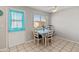 Bright dining area features a large window and tile flooring at 7546 E Clovis Cir, Mesa, AZ 85208