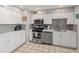 Kitchen boasts white cabinets and stainless steel appliances at 7546 E Clovis Cir, Mesa, AZ 85208