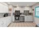 The kitchen features white cabinets, stainless appliances, and gray subway tile backsplash at 7546 E Clovis Cir, Mesa, AZ 85208