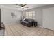 Spacious living room with tile floors, ceiling fan, and a comfortable gray sofa at 7546 E Clovis Cir, Mesa, AZ 85208