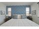 Well lit main bedroom with luxurious bedding, accent wall, and stylish nightstands for a serene retreat at 10839 W Lincoln St, Avondale, AZ 85323