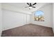 Bright bedroom with a large arched window and neutral carpet at 1202 W Sand Hills Ct, Gilbert, AZ 85233