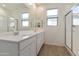 Bright bathroom featuring a dual sink vanity, ample counter space, and glass enclosed shower at 12738 N 172Nd Dr, Surprise, AZ 85388
