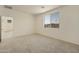 Spacious bedroom with a large window offering exterior views and an open doorway to the rest of the home at 12738 N 172Nd Dr, Surprise, AZ 85388