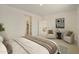 Bright bedroom featuring plush carpet, modern decor, and a view into the ensuite bathroom and closet at 12738 N 172Nd Dr, Surprise, AZ 85388
