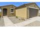 View of the charming home with a two-car garage, desert landscaping, and a covered front entry at 12738 N 172Nd Dr, Surprise, AZ 85388
