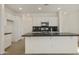 Bright kitchen boasting white cabinets, stainless steel appliances, a dark countertop island, and hexagon backsplash at 12738 N 172Nd Dr, Surprise, AZ 85388