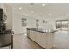 Open-concept kitchen with a kitchen island and stainless steel appliances that flows to the living area at 12738 N 172Nd Dr, Surprise, AZ 85388