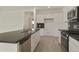Contemporary kitchen featuring white cabinets, stainless steel appliances, dark counters, and an island at 12738 N 172Nd Dr, Surprise, AZ 85388