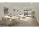Bright, airy living room featuring modern furnishings, light wood floors, and a sliding glass door to the backyard at 12738 N 172Nd Dr, Surprise, AZ 85388