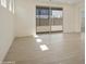 Bright open room with light tile flooring and a large sliding glass door providing natural light at 12738 N 172Nd Dr, Surprise, AZ 85388