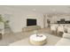 Open living space with light wood floors, modern furniture, and an adjacent kitchen area, perfect for gatherings at 12738 N 172Nd Dr, Surprise, AZ 85388