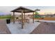 Shaded picnic area equipped with a table and grill offers a relaxing space for outdoor dining and gatherings at 12738 N 172Nd Dr, Surprise, AZ 85388