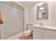 Bright bathroom featuring a glass shower, white cabinets, modern fixtures, and a skylight for a fresh and airy feel at 12834 W Ashwood Dr, Sun City West, AZ 85375