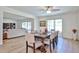 Bright dining room with wood tile flooring, a large dining table and an open design at 12834 W Ashwood Dr, Sun City West, AZ 85375