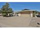 Charming home exterior with attached two-car garage and mature landscaping at 12834 W Ashwood Dr, Sun City West, AZ 85375