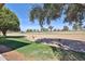 Backyard view of golf course featuring mature landscaping and stone accents at 12834 W Ashwood Dr, Sun City West, AZ 85375