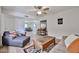 Bright living room with neutral walls, ceiling fan and stylish furnishings, including a coffee table at 12834 W Ashwood Dr, Sun City West, AZ 85375