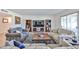 Spacious living room featuring a media center, book shelves, and comfortable seating with a rug at 12834 W Ashwood Dr, Sun City West, AZ 85375