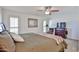 Tranquil main bedroom with a ceiling fan, soft lighting, and a cozy bed creating a relaxing and inviting atmosphere at 12834 W Ashwood Dr, Sun City West, AZ 85375