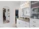 Bright bathroom with granite counters, white cabinets, and a view to the closet with ample storage space at 12873 N 175Th Dr, Surprise, AZ 85388