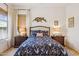 Cozy bedroom featuring a patterned bedspread, matching nightstands, and elegant décor at 12873 N 175Th Dr, Surprise, AZ 85388