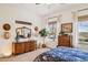 Bright bedroom showcasing a dresser with a mirror, decorative hats, and a cozy ambiance at 12873 N 175Th Dr, Surprise, AZ 85388